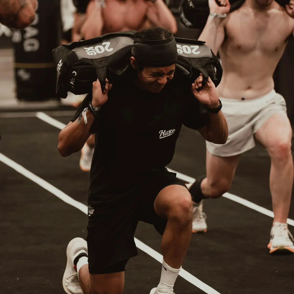 An athlete doing sandbag lunges