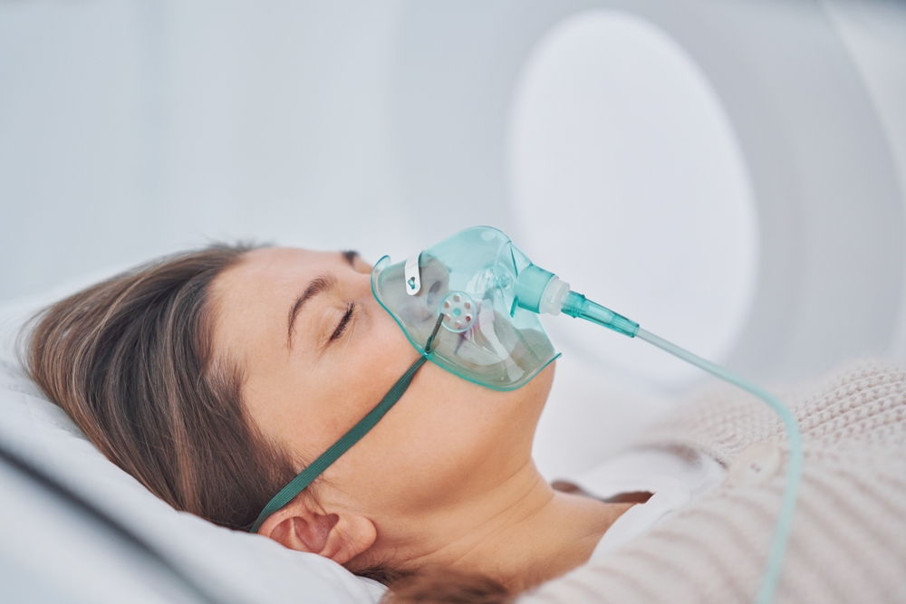 Client resting with an oxygen mask during a session